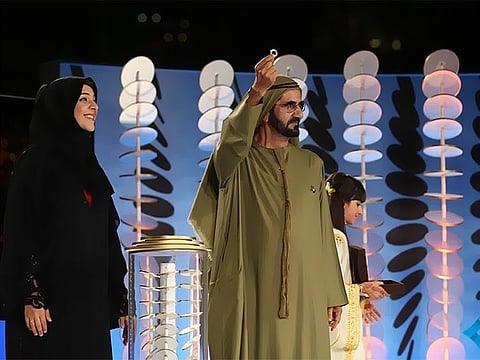 His Highness Sheikh Mohammed, Vice President and Prime Minister of the United Arab Emirates and Ruler of Dubai, with Reem Al Hashemi, Director General of the Dubai Expo 2020 Office, presented the excavated gold ring that inspired the Expo 2020 logo at Burj Khalifa in Dubai, 2016.