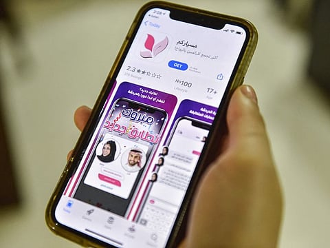 A woman holds a phone showing an app for facilitating "Misyar" marriage in Riyadh in a file photo.