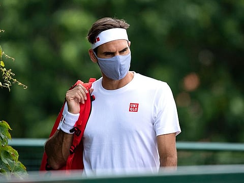 Switzerland's Roger Federer leaves a practice session at Wimbledon