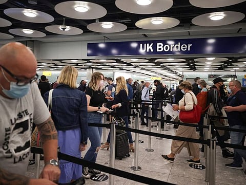 Arriving passengers queue at UK Border Control at the Terminal 5 at Heathrow Airport in London on June 29, 2021.  Heathrow airport said it plans to offer fast-track lanes for fully-vaccinated arriving passengers, as the UK government winds down its pandemic curbs.