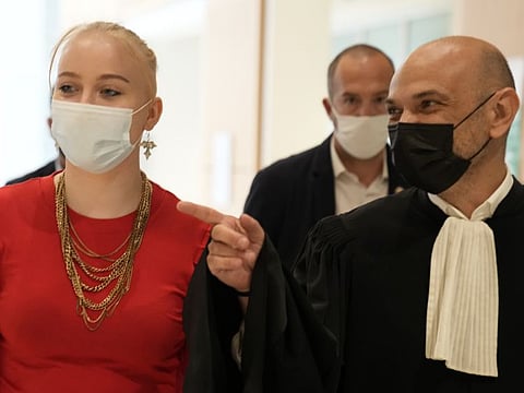 The teenager identifying herself online as Mila leaves at the courtroom with her lawyer Richard Malka, in Paris, in a file photo.
