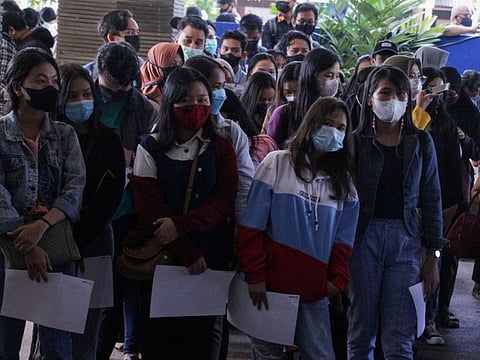 College students wearing protective face masks queue up for COVID-19 vaccine, as cases surge in Palangkaraya, Central Kalimantan Province, Indonesia, on July 7, 2021.