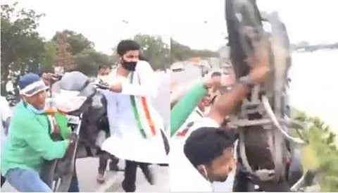 Youth Congress workers throwing motorcycle in Hussain Sagar lake in Hyderabad last month.
