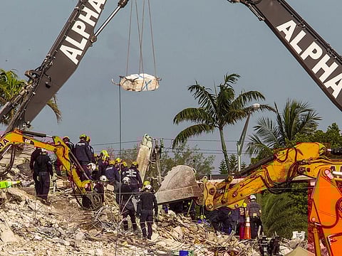 Members of the Pennsylvania Search and Rescue team search for victims at a collapsed South Florida condo building in Surfside, Florida.