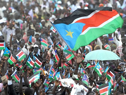 File photo taken on July 9, 2011: Thousands of Southern Sudanese wave the flag of their new country during a ceremony in the capital Juba to celebrate South Sudan's independence from Sudan.