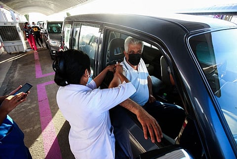 A medic administers a dose of a COVID-19 vaccine at a drive-thru inoculation site at the Jaber Al Ahmad Al Sabah causeway in Kuwait City, on July 5, 2021.