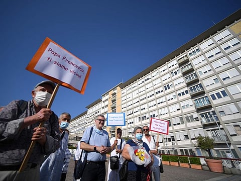 Believers gather and pray near the Policlinico A. Gemelli Hospital in Rome, on July 9, 2021, where Pope Francis is resting after undergoing a planned three-hour operation on July 4, for what the Vatican described as symptomatic diverticular stenosis of the colon.