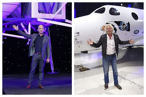 Jeff Bezos in front of a model of Blue Origin's Blue Moon lunar lander in Washington in a file photo. Sir Richard Branson poses in front of Virgin Galactic’s SpaceShipTwo space tourism rocket after it was unveiled in a file photo. Nasa Administrator Jim Bridenstine has said space is currently a $400 billion market, including satellites. Opening up spaceflight to paying customers, he said, could expand the market to $1 trillion.