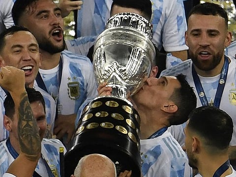 Argentina's Angel Di Maria kisses the trophy after winning the Conmebol 2021 Copa America football tournament final match against Brazil at Maracana Stadium in Rio de Janeiro, Brazil, on July 10, 2021