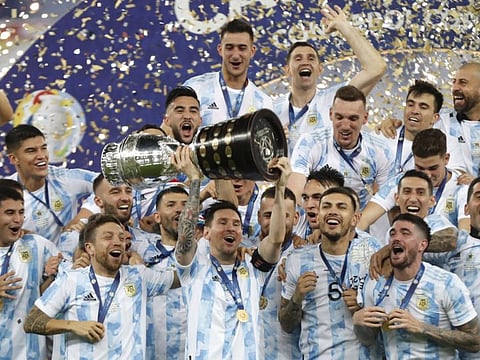 Argentina's Lionel Messi (centre) holds the trophy as he celebrates with teammates after beating 1-0 Brazil in the Copa America final at the Maracana stadium in Rio de Janeiro, Brazil.