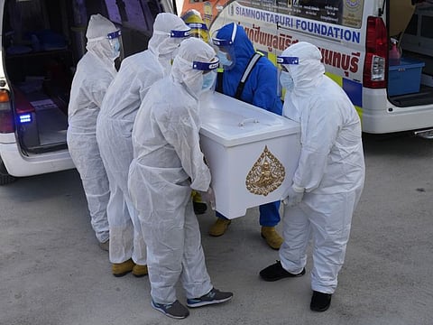 Siam Nonthaburi Foundation volunteers in full protective suits carrying coffin a COVID-19 victim for free funeral ceremony service at Wat Ratprakongtham temple Nonthaburi Province, Thailand, on July 12, 2021.