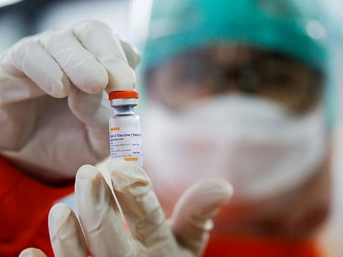 A medical worker holds a dose of the Sinovac's vaccine at a district health facility in in Jakarta.