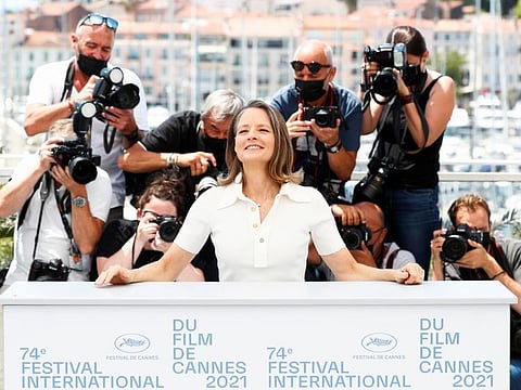 Actress Jodie Foster poses during a photocall before being awarded with an honorary Palme d'Or prize, during the opening ceremony.