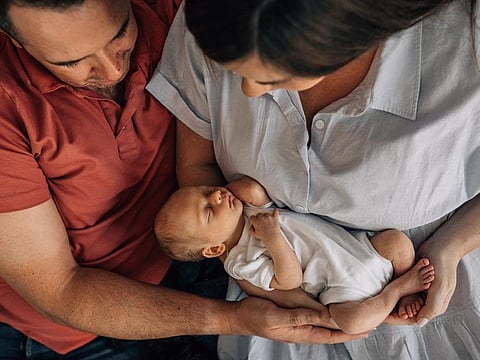 Tom Hoban with his wife and baby
