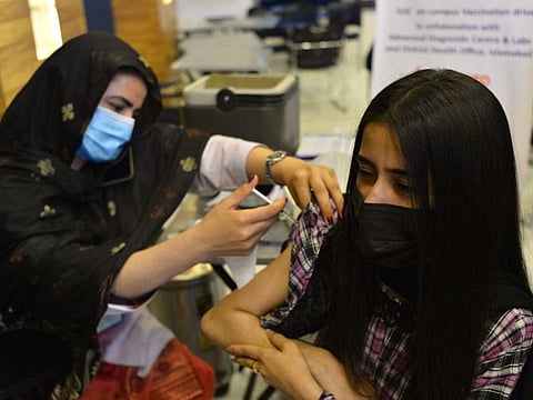 A student receives a dose of coronavirus vaccine at a university in Islamabad last month. Pakistan aims to vaccinate 70 million eligible people by the end of 2021.