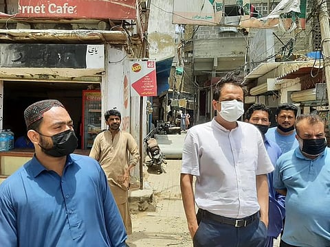 Murtaza Wahab, (in white shirt) inspects ongoing development works in Karachi in a file photo.