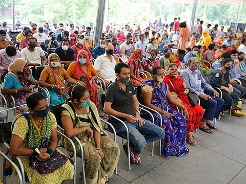 People await their turn to get vaccinated for COVID-19 at a vaccination centre in Ahmedabad, India, Friday, July 16, 2021.