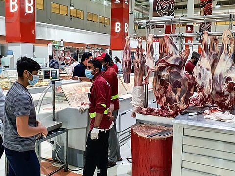 Shoppers buying meat at The Waterfront Market in Deira.