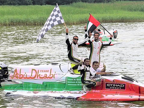The Abu Dhabi 1 crew of Rashed Al Qemzi, Thani Al Qemzi and Mansoor Al Mansoori with team manager Guido Cappellini