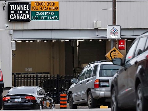 In this March 16, 2020, file photo, vehicles enter the Detroit-Windsor Tunnel in Detroit to travel to Canada.