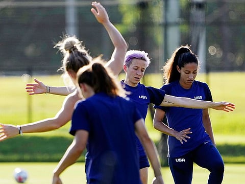 Megan Rapinoe, second right, and her Olympic football teammates warm up at a training session