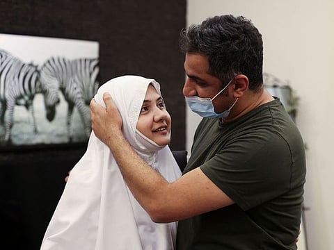 Pakistani pilgrim Bushra Ali Shah, 35, bids her husband farewell before departing to Hajj, for the first time without a male guardian, from her home in Saudi Arabia's Red Sea coastal city of Jeddah, on July 16, 2021.