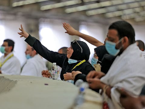 The faithful cast pebbles during a symbolic stoning of the devil ritual, as part of the Hajj pilgrimage in Mina, near Saudi Arabia's holy city of Mecca, on July 20, 2021.