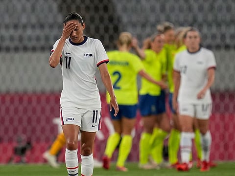 United States' Christen Press reacts as Sweden's players celebrate their third goal at the 2020 Tokyo Olympics