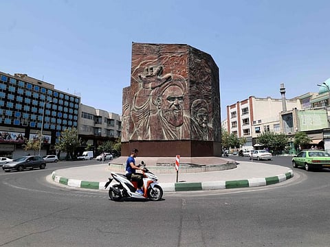 An Iranian rides a motorbike at Enghelab square in Tehran, on July 20, 2021. As the country struggles to contain the virus, street protests over water shortages in southwest continued for a sixth night on Tuesday amid rising violence.
