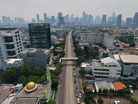 A road leading to the city centre usually filled with traffic is pictured deserted in Jakarta, after the government imposed restrictions two weeks ago on public activities to reduce the spread of COVID-19.