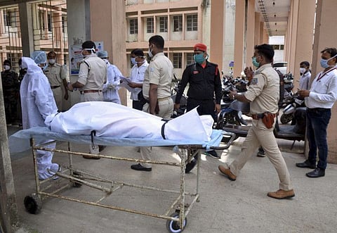 Health workers shift the body of Usha Devi, suspected to have died due to mucormycosis (black fungus), in Ranchi, on July 11, 2021.