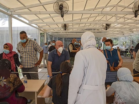 Health workers take the details of residents inside the registration area of a vaccination centre at the Rafik Hariri University. Hospitals are unable to find fuel oil to power generators during power outages of at least 20 hours a day. Hospital in Beirut.