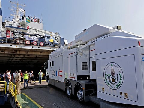 A boat unloads a scanner offered by the French government to the Lebanese customs at Beirut port on July 23, 2021. The ship also carries 136 tonnes of humanitarian aid to Lebanon.