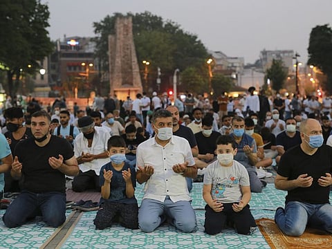 Muslims offer prayers during the first day of Eid Al Adha, outside the iconic Haghia Sophia in the historic Sultan Ahmed district of Istanbul on July 20, 2021.