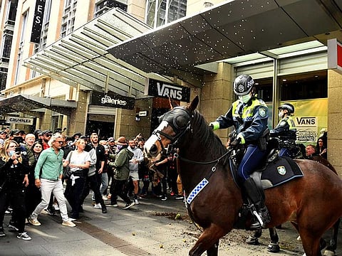 Protesters throw plastic bottles and pot plants at mounted police in the city centre during an anti-lockdown rally as an outbreak of the coronavirus disease (COVID-19) affects Sydney, Australia, July 24, 2021.