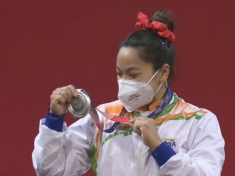 Indian weightlifter Mirabai Chanu admires her silver medal in the 49 kg class in Tokyo on Saturday.