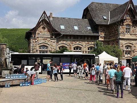 People queue to receive a dose of the vaccine against the coronavirus disease (COVID-19) in a bus, after floods caused by heavy rainfalls, in Ahrweiler Bad Neuenahr-Ahrweiler, Rhineland-Palatinate state, Germany, July 20, 2021.