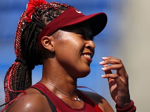 Naomi Osaka of Japan is all smiles after winning her first round match against Zheng Saisai of China.