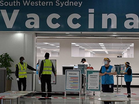 Staff get ready to process residents at a newly opened COVID-19 vaccination centre in a suburb of Sydney on July 26, 2021, as around half of Australia's 25 million largely unvaccinated residents are currently under stay-at-home orders.