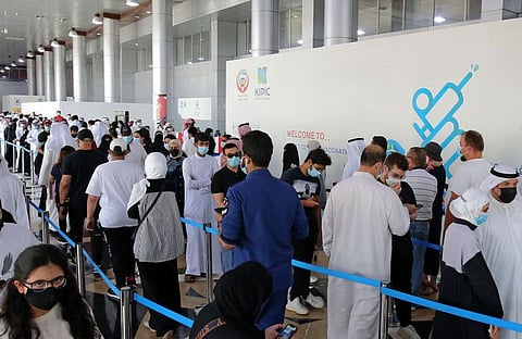 People queue up to receive a dose of a vaccine during the first day of the Eid Al Adha , at a vaccination centre in Kuwait City, on July 20.