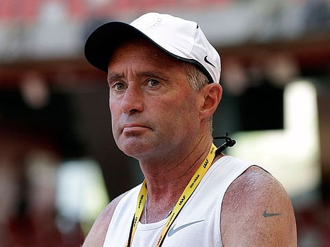 In this Aug. 21, 2015, file photo, Alberto Salazar watches a training session for the World Athletic Championships at the Bird's Nest stadium in Beijing.