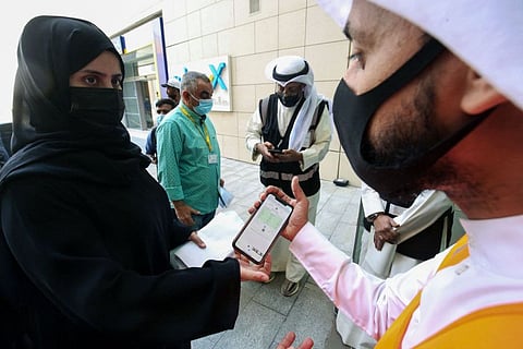 Kuwaitis queue as officials verify their vaccination certificates before allowing entry to The Avenues Mall in Kuwait City, the country's largest shopping centre in a file photo..