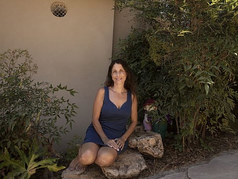 Idit Harel Segal, who donated a kidney to a Palestinian child from the Gaza Strip, poses for a portrait in her home in Eshhar, northern Israel.