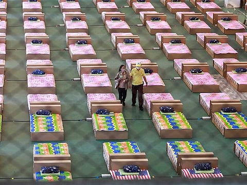 Volunteers walk as they prepare to convert an air cargo warehouse into a coronavirus disease (COVID-19) field hospital at Don Mueang International Airport in Bangkok, Thailand July 28, 2021.