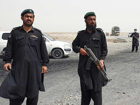 Frontier constabulary personnel stand guard in the border town of Chaman on July 16, 2021, following clashes between Afghan forces and Taliban fighters in Spin Boldak to retake the key border crossing with Pakistan.