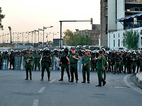 Security forces close the Joumhouriya Bridge that leads to the Green Zone government areas during a protest in Baghdad, Iraq, Sunday, July 18, 2021.