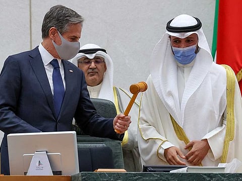 US Secretary of State Antony Blinken holds the speaker’s gavel as he tours the National Assembly with assembly Speaker Marzouq Ali Mohammed Al Ghanim in Kuwait City, Kuwait July 29, 2021.