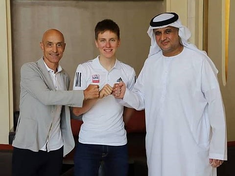 From right to left: Matar Suhail Al Yabhouni Al Dhaheri, UAE Team Emirates President, Tadej Pogacar and Mauro Gianetti, Team Principal & CEO.