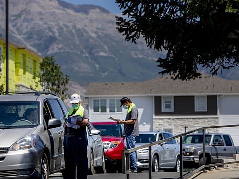 Healthcare workers register residents arriving to get tested at a Utah County Health Department drive-thru testing site in American Fork, Utah, US, on July 20, 2021. The Delta variant has torn through Utah, fueled by low vaccination rates among younger people, the exuberant return of summer gatherings and loose restrictions imposed by public and private authorities.