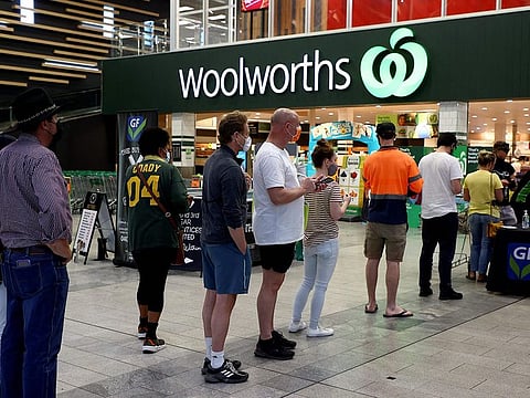 Residents queue up outside a shopping centre in eastern Brisbane on July 31, 2021, as Australia’s third-largest city Brisbane and other parts of Queensland state will enter a snap lockdown.